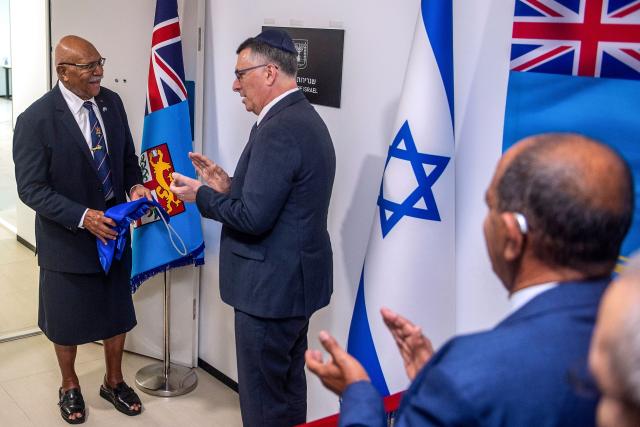 In this photo taken on June 2, 2026, Israeli Foreign Minister Gideon Sa'ar (C) reacts with Fiji Prime Minister Sitiveni Rabuka (L) during an official ceremony at the new Israeli embassy in Suva. (Photo by Leon Lord / AFP)