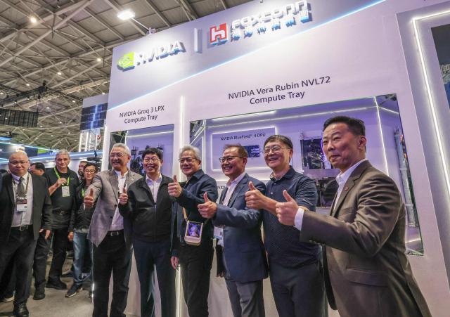 Nvidia CEO Jensen Huang (C) meets Foxconn CEO Young Liu (C-L) at the booth of Foxconn during Computex 2026 in Taipei on June 3, 2026. (Photo by I-Hwa Cheng / AFP)