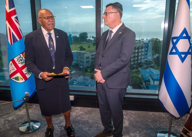 In this photo taken on June 2, 2026, Israeli Foreign Minister Gideon Sa'ar (R) listens as Fiji Prime Minister Sitiveni Rabuka (L) speaks during an official ceremony at the new Israeli embassy in Suva. (Photo by Leon Lord / AFP)