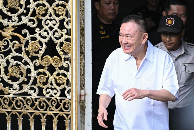 (FILES) Thailand's former prime minister Thaksin Shinawatra looks on as he is greeted by family members and relatives upon his release at Klong Prem Central Prison in Bangkok on May 11, 2026. Thaksin Shinawatra has met the conditions for royal pardon as part of a clemency measure marking the queen's birthday, the justice minister said on June 3, 3026. Thaksin, 76, served eight months of a one-year sentence for corruption and abuse of power before he was released on parole last month due to his age. (Photo by Lillian SUWANRUMPHA / AFP)