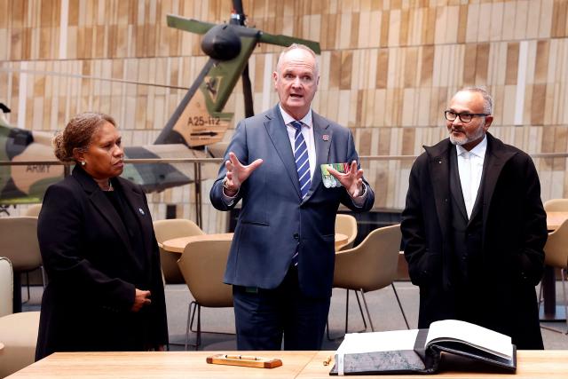 Director of the Australian War Memorial Matt Anderson (C) speaks as he stands with Solomon Islands Prime Minister Matthew Wale (R) and his wife Veronica Ruala Waletofea during a visit to the Australian War Memorial in Canberra on June 3, 2026. (Photo by Hilary Wardhaugh / AFP)