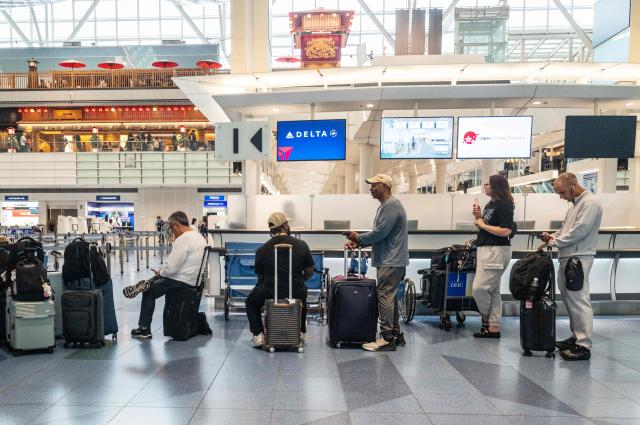 Passengers wait at the International Terminal at Haneda airport after flights were cancelled or severely delayed because of severe tropical storm Jangmi in Tokyo on June 3, 2026. A severe tropical storm moved towards Tokyo on June 3, with forecasters warning of floods after torrential rain battered swathes of the country and prompted calls to evacuate for hundreds of thousands of people. (Photo by Andrew CABALLERO-REYNOLDS / AFP)