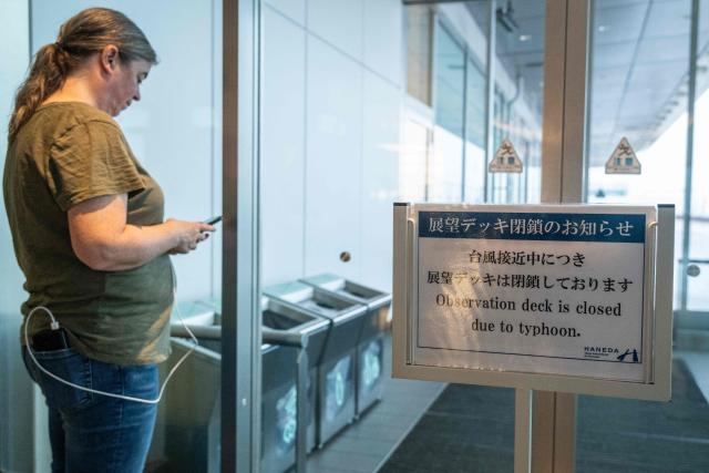 The flight board is seen at the International Terminal at Haneda airport after flights were cancelled or severely delayed because of severe tropical storm Jangmi in Tokyo on June 3, 2026. A severe tropical storm moved towards Tokyo on June 3, with forecasters warning of floods after torrential rain battered swathes of the country and prompted calls to evacuate for hundreds of thousands of people. (Photo by Andrew CABALLERO-REYNOLDS / AFP)