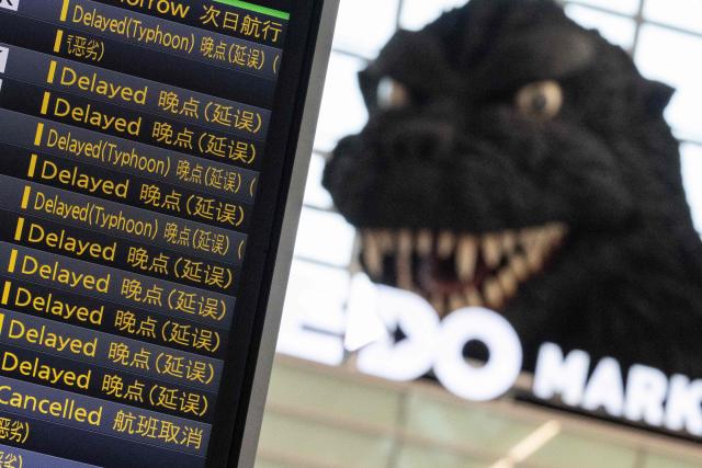The flight board is seen at the International Terminal at Haneda airport after flights were cancelled or severely delayed because of severe tropical storm Jangmi in Tokyo on June 3, 2026. A severe tropical storm moved towards Tokyo on June 3, with forecasters warning of floods after torrential rain battered swathes of the country and prompted calls to evacuate for hundreds of thousands of people. (Photo by Andrew CABALLERO-REYNOLDS / AFP)