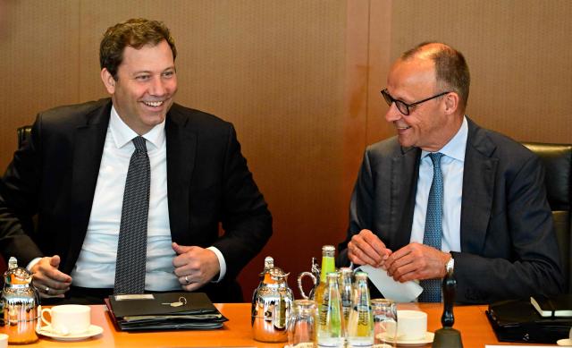 German Chancellor Friedrich Merz (R) and German Finance Minister and Vice Chancellor Lars Klingbeil have taken their seats for the weekly cabinet meeting at the Chancellery in Berlin on June 3, 2026. (Photo by Tobias SCHWARZ / AFP)