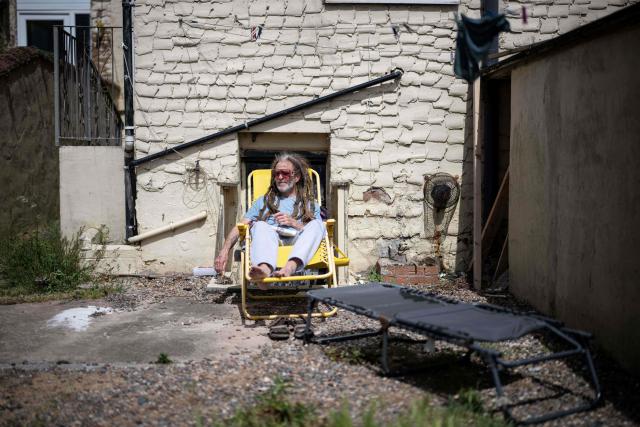 A man relaxes on a sun lounge in his yard in central Blackpool, north-west England on June 2, 2026. (Photo by Oli SCARFF / AFP)