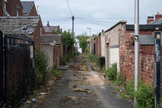 A cat strolls along a rear alley to residential properties in central Blackpool, north-west England on June 2, 2026. (Photo by Oli SCARFF / AFP)