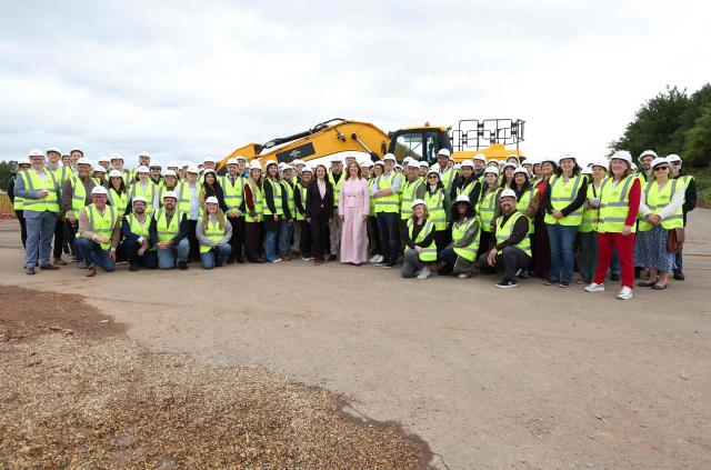 Britain's Chancellor of the Exchequer Rachel Reeves poses for a group photo with workers during a visit to the site where the Universal United Kingdom theme park is planned to be built, near Bedford, north of London on June 3, 2026. (Photo by Chris Radburn / POOL / AFP)