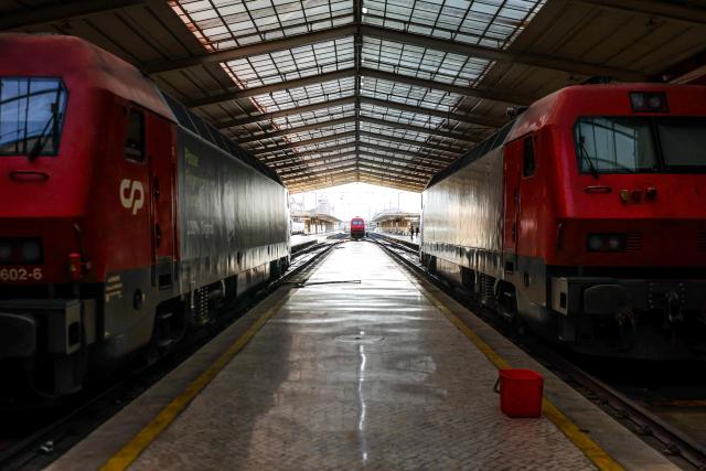 Trains stand idle along empty platforms at Santa Apolonia train station during a nationwide general strike in Lisbon on June 3, 2026. Public transport and municipal services were severely disrupted in Portugal on Wednesday due to a 24-hour general strike over proposed labour reforms. The stoppage hit transport companies as well as waste collection, hospitals and schools, according to the General Confederation of Portuguese Workers (CGTP). (Photo by PATRICIA DE MELO MOREIRA / AFP)