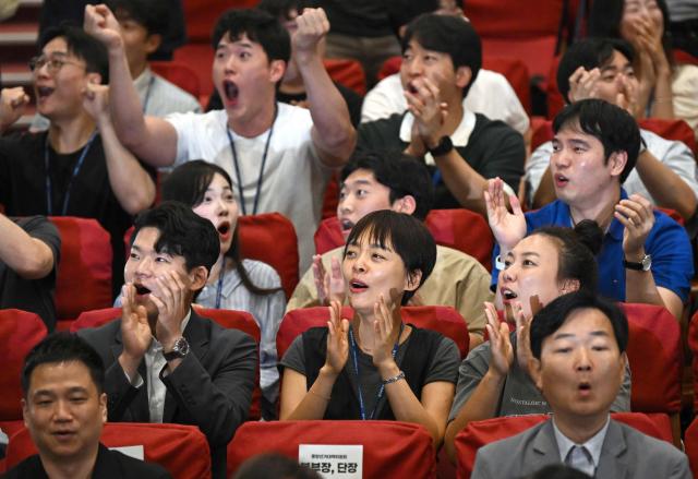 South Korea's ruling Democratic Party members react as they watch television screens broadcasting the results of exit polls for the nationwide local elections at the National Assembly in Seoul on June 3, 2026. (Photo by Jung Yeon-je / AFP)