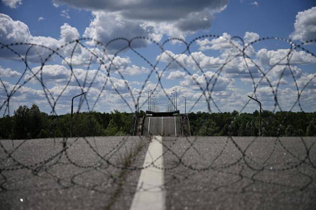 This general view shows a destroyed bridge over the Dnipro River, which forms the state border between Ukraine and Belarus in the Chernigiv region, on June 1, 2026, amid the Russian invasion of Ukraine. (Photo by Genya SAVILOV / AFP)