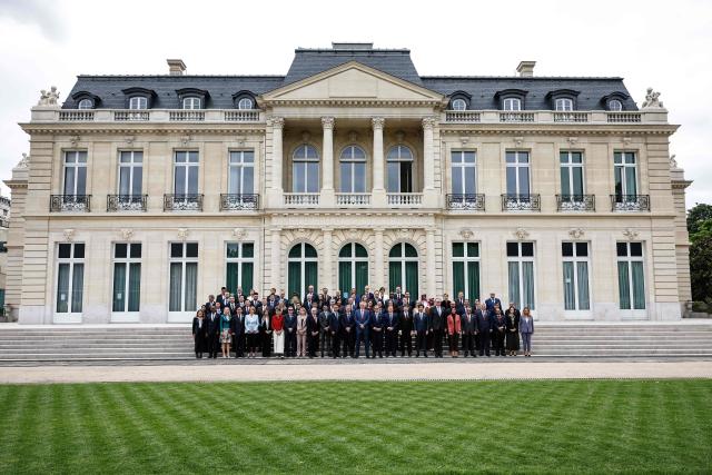 Attendees including Secretary-General of the Organisation for Economic Co-operation and Development (OECD) Mathias Cormann (C) pose during a family photograph at the OECD 2026 Ministerial Council Meeting (MCM) at the Organisation for Economic Co-operation and Development (OECD) headquarters in Paris on June 3, 2026. (Photo by SIMON WOHLFAHRT / AFP)