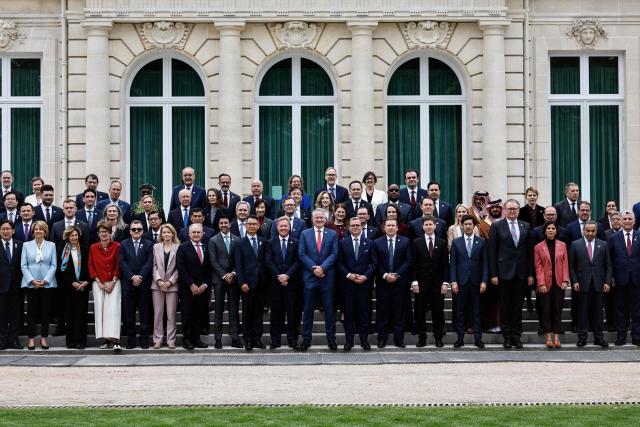 Attendees including Secretary-General of the Organisation for Economic Co-operation and Development (OECD) Mathias Cormann (C) pose during a family photograph at the OECD 2026 Ministerial Council Meeting (MCM) at the Organisation for Economic Co-operation and Development (OECD) headquarters in Paris on June 3, 2026. (Photo by SIMON WOHLFAHRT / AFP)