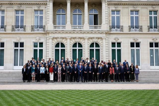 Attendees including Secretary-General of the Organisation for Economic Co-operation and Development (OECD) Mathias Cormann (C) pose during a family photograph at the OECD 2026 Ministerial Council Meeting (MCM) at the Organisation for Economic Co-operation and Development (OECD) headquarters in Paris on June 3, 2026. (Photo by SIMON WOHLFAHRT / AFP)
