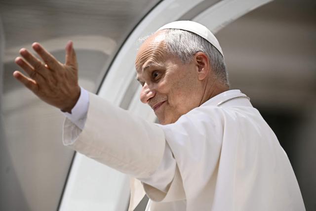 Pope Leo XIV waves to pilgrims from atop the Popemobile at the end of the weekly general audience in St. Peter's Square at The Vatican on June 3, 2026. (Photo by Filippo MONTEFORTE / AFP)