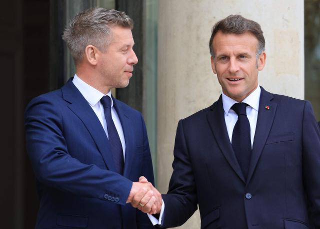 France's President Emmanuel Macron (R) welcomes Hungary's Prime Minister Peter Magyar ahead of a meeting at The Elysee Presidential Palace in Paris on June 3, 2026. (Photo by Ludovic MARIN / AFP)