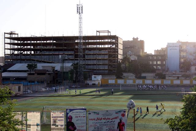 Iranian children play football in a field in Tehran on May 8, 2026. Iran's national team, also known as TeamMelli, open their 2026 World Cup campaign, co-hosted by the United States, Mexico and Canada, against New Zealand in Los Angeles on June 15 before lining up against Belgium and Egypt in Group G. Iran has been at war with the United States and Israel since February 28, though a fragile ceasefire has been in place since April 8. Tehran and Washington have had no diplomatic relations since 1980 following the hostage crisis at the US embassy, which came after the Islamic revolution that toppled the US-backed shah. (Photo by AFP)