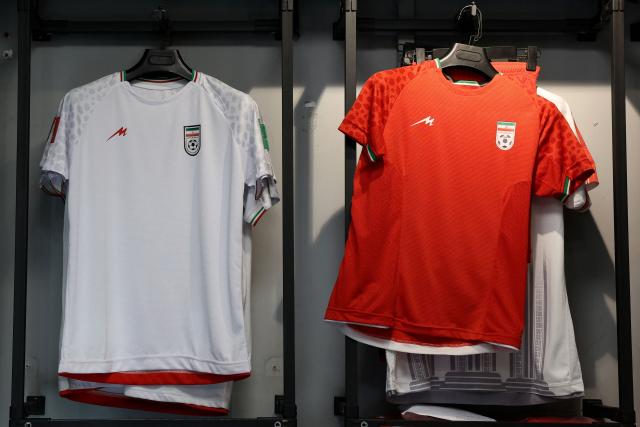 Iran's national football jerseys are displayed for sale in a shop in Tehran on May 8, 2026. Iran's national team, also known as TeamMelli, open their 2026 World Cup campaign, co-hosted by the United States, Mexico and Canada, against New Zealand in Los Angeles on June 15 before lining up against Belgium and Egypt in Group G. Iran has been at war with the United States and Israel since February 28, though a fragile ceasefire has been in place since April 8. Tehran and Washington have had no diplomatic relations since 1980 following the hostage crisis at the US embassy, which came after the Islamic revolution that toppled the US-backed shah. (Photo by AFP)