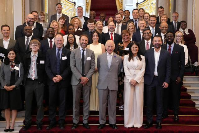 Britain's King Charles III (C) poses alongside former England football manager and King’s Trust Goodwill Ambassador Gareth Southgate (centre L) and Britain's Culture Secretary Lisa Nandy (centre R) for a group photograph as he hosts a Youth Opportunity Summit at a reception at Buckingham Palace in London on June 3, 2026. (Photo by Andrew Matthews / POOL / AFP)
