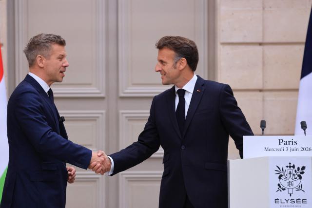 France's President Emmanuel Macron (R) shakes hands with Hungary's Prime Minister Peter Magyar at the end of a joint press conference after a meeting at The Elysee Presidential Palace in Paris on June 3, 2026. (Photo by Ludovic MARIN / POOL / AFP)