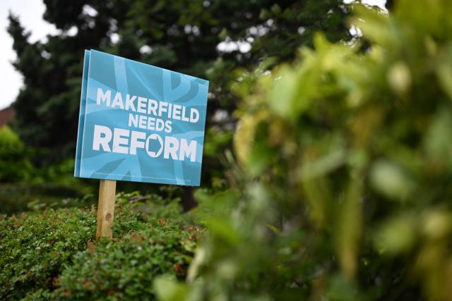 A banner for Reform UK political party is pictured in the garden of a residential property in Ashton-in-Makerfield, west of Manchester in north-west England on June 03, 2026, ahead of the Makerfield by-election. The Makerfield by-election, set to be held on June 18, may see Greater Manchester mayor Andy Burnham return to the government though he would face a tough fight from the poll-topping Reform UK. (Photo by Oli SCARFF / AFP)