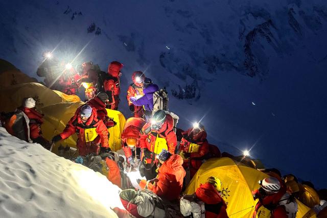 (FILES) This photograph taken on May 19, 2026, shows mountaineers leaving from Camp 3 to continue their ascent to summit Mount Everest in Nepal. More than one thousand climbers reached the summit of Mount Everest this season, officials said on June 3, making it the busiest season on record. (Photo by Furte Sherpa / AFP)