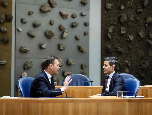 Dutch Minister of Finance Eelco Heinen (L) and Prime Minister Rob Jetten (R) chat during the accountability debate in the House of Representatives regarding the year 2025, in The Hague on June 3, 2026. (Photo by Remko de Waal / ANP / AFP) / Netherlands OUT