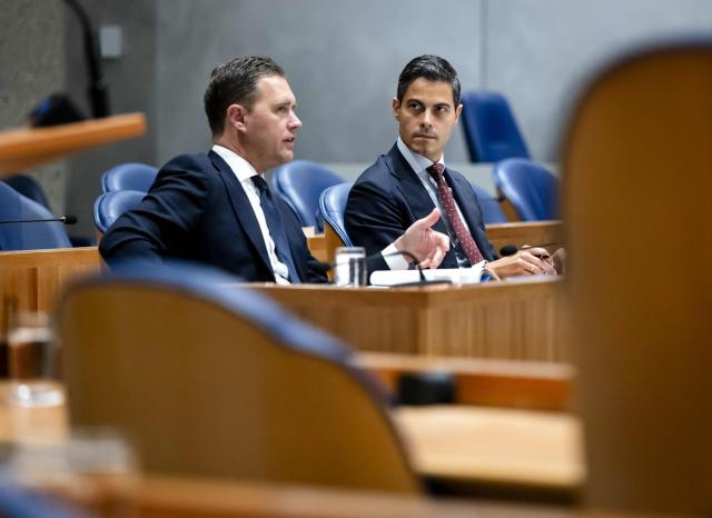 Dutch Minister of Finance Eelco Heinen (L) and Prime Minister Rob Jetten (R) chat during the accountability debate in the House of Representatives regarding the year 2025, in The Hague on June 3, 2026. (Photo by Remko de Waal / ANP / AFP) / Netherlands OUT
