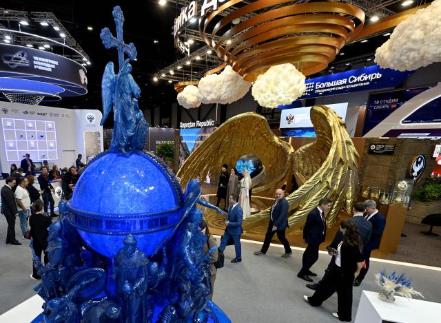 Participants tour an exhibition of the St. Petersburg International Economic Forum (SPIEF) in Saint Petersburg on June 3, 2026. (Photo by Olga MALTSEVA / AFP)