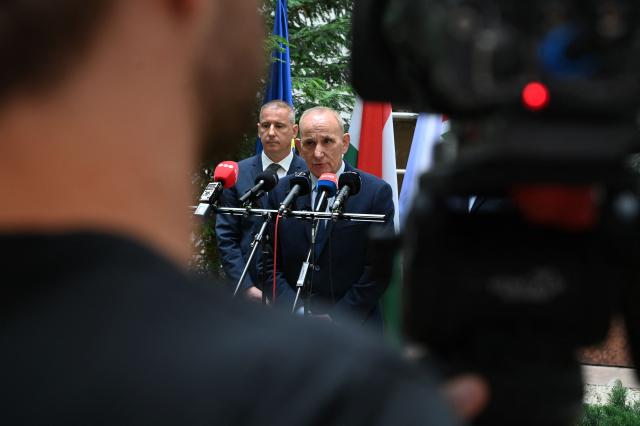 Godollo mayor Gyorgy Gemesi (C) and Szombathely mayor Andras Nemely (C-L), representing organisations advocating for municipal governments, arrive to give a joint press conference on June 3, 2026, at the Ministry for Rural and Regional Development in Budapest, Hungary, following their meeting. Hungary's new government, which took office in May 2026, promised that powers, resources, and responsibilities previously taken away by former prime minister Viktor Orban's government would be returned to the municipalities. But no change has been implemented yet. (Photo by ATTILA KISBENEDEK / AFP)