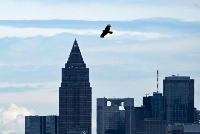 A bird flies above MesseTurm skyscraper building in Frankfurt am Main, western Germany, on June 3, 2026. (Photo by Kirill KUDRYAVTSEV / AFP)