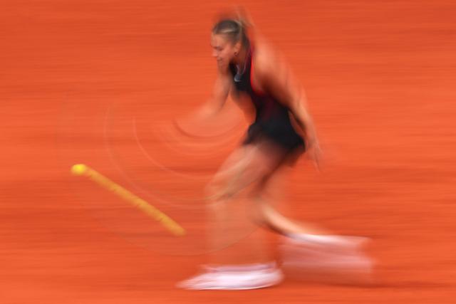 Aryna Sabalenka plays a backhand return to Diana Shnaider during their women's quarter final singles match on day 11 of the French Open tennis tournament on Court Philippe-Chatrier at the Roland-Garros Complex in Paris on June 3, 2026. (Photo by Anne-Christine POUJOULAT / AFP)