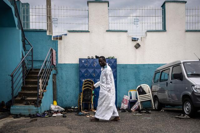 A worshipper leaves the church during a service at the Celestial Church of Christ International Headquarters in the Ketu neighbourhood of Lagos, on June 3, 2026. (Photo by OLYMPIA DE MAISMONT / AFP)