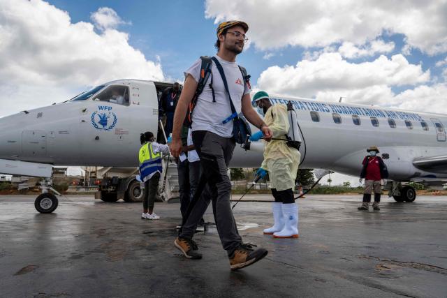 An aid worker walks at Bunia Airport in eastern Democratic Republic of the Congo on June 3, 2026. On May 23, DRC authorities announced the temporary closure of Bunia Airport, located in the capital of Ituri Province, where the 17th Ebola outbreak is raging. The airport reopened on June 2. To date, 48 deaths have been reported among 321 confirmed cases of infection, according to Congolese health authorities and the WHO. (Photo by GLODY MURHABAZI / AFP)