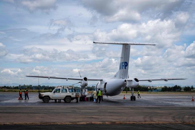 A general view of a World Food Programme (WFP) humanitarian aircraft parked at Bunia Airport in eastern Democratic Republic of the Congo on June 3, 2026. On May 23, DRC authorities announced the temporary closure of Bunia Airport, located in the capital of Ituri Province, where the 17th Ebola outbreak is raging. The airport reopened on June 2. To date, 48 deaths have been reported among 321 confirmed cases of infection, according to Congolese health authorities and the WHO. (Photo by GLODY MURHABAZI / AFP)