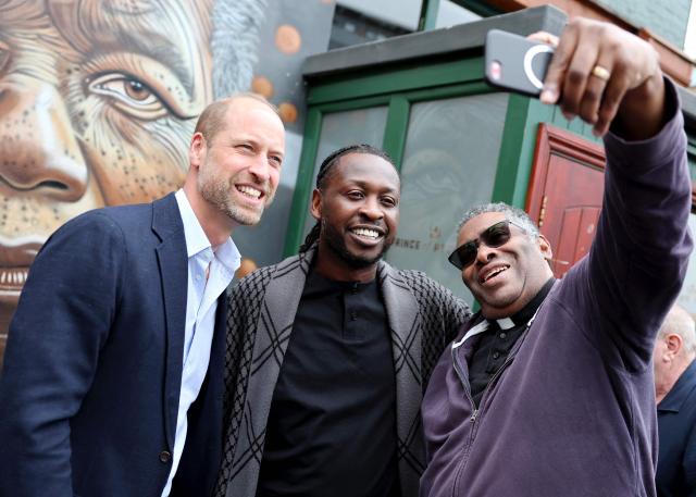 Britain's Prince William, Prince of Wales poses for a photograph with pub founder Clement Ogbonnaya outside The Prince of Peckham Pub in Peckham, south east London on June 3, 2026, the pub has become a hub for local communities, hosting  events and initiatives aimed at fostering connection and combatting loneliness. (Photo by Chris Jackson / POOL / AFP)