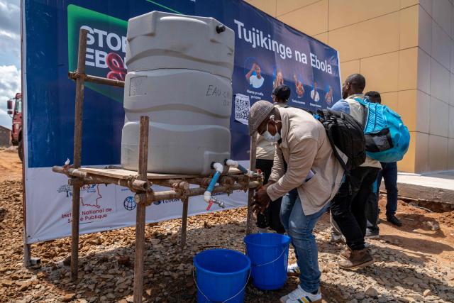 A passenger washes his hands at Bunia Airport in eastern Democratic Republic of the Congo on June 3, 2026. On May 23, DRC authorities announced the temporary closure of Bunia Airport, located in the capital of Ituri Province, where the 17th Ebola outbreak is raging. The airport reopened on June 2. To date, 48 deaths have been reported among 321 confirmed cases of infection, according to Congolese health authorities and the WHO. (Photo by GLODY MURHABAZI / AFP)