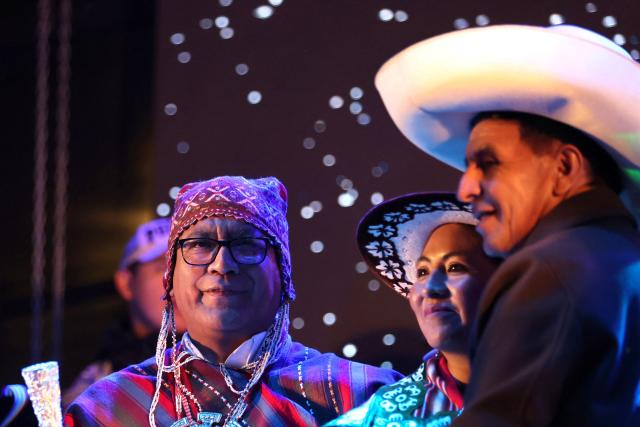Peru's presidential candidate for the Juntos por el Peru party, Roberto Sanchez (L) and his running mate for first Vice-President Anali Marquez (C), attend a campaign rally at the Plaza Tupac Amaru in Cusco, Peru, on June 2, 2026. Peruvians will choose their president on June 7, 2026, between right-wing candidate Keiko Fujimori, heir to a political dynasty that divides the nation, and left-wing candidate Roberto Sáncheztwo diametrically opposed visions for a country plagued by instability and crime. (Photo by Jose Angulo / AFP)