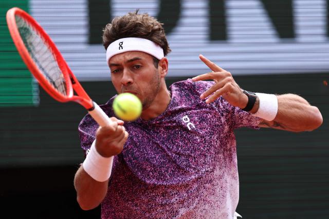 Italy's Flavio Cobolli plays a forehand return to Canada's Felix Auger-Aliassime during their men's quarter final singles match on day 11 of the French Open tennis tournament on Court Philippe-Chatrier at the Roland-Garros Complex in Paris on June 3, 2026. (Photo by Anne-Christine POUJOULAT / AFP)