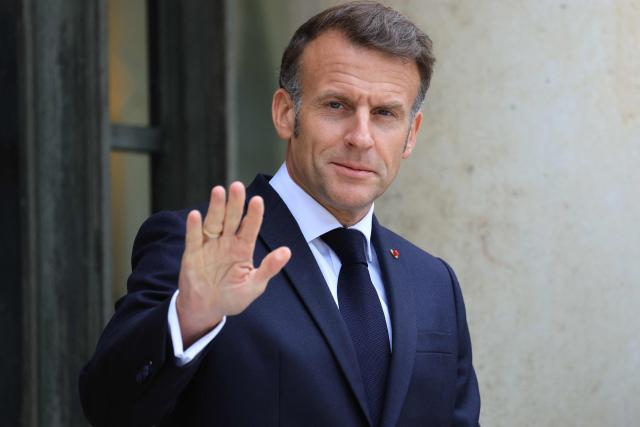 France's President Emmanuel Macron waves as he waits to welcome Finland's prime minister at The Elysee Presidential Palace in Paris on June 3, 2026. (Photo by Ludovic MARIN / AFP)