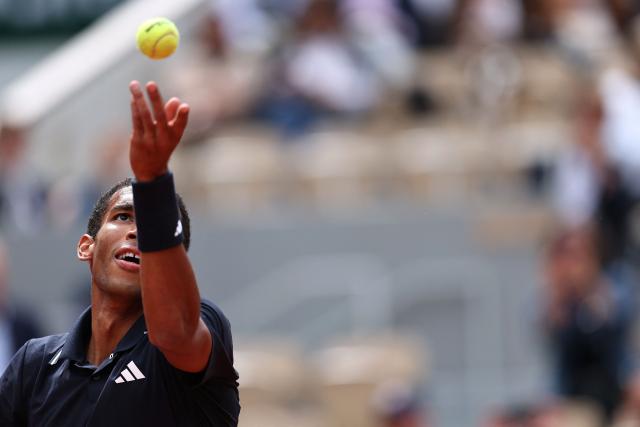 Canada's Felix Auger-Aliassime serves to Italy's Flavio Cobolli during their men's quarter final singles match on day 11 of the French Open tennis tournament on Court Philippe-Chatrier at the Roland-Garros Complex in Paris on June 3, 2026. (Photo by Anne-Christine POUJOULAT / AFP)