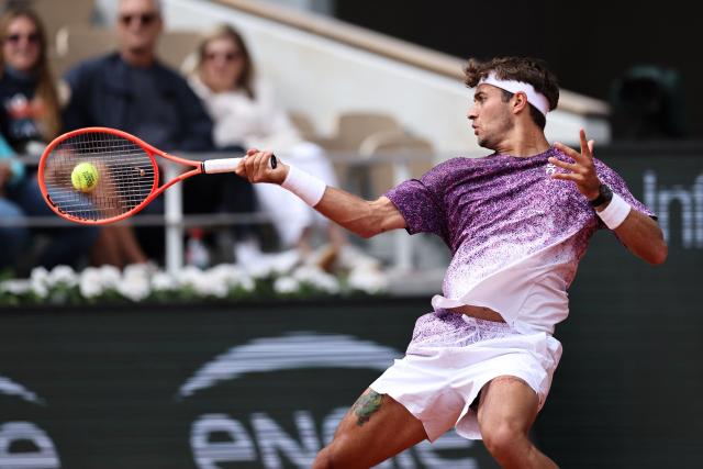 Italy's Flavio Cobolli plays a forehand return to Canada's Felix Auger-Aliassime during their men's quarter final singles match on day 11 of the French Open tennis tournament on Court Philippe-Chatrier at the Roland-Garros Complex in Paris on June 3, 2026. (Photo by Anne-Christine POUJOULAT / AFP)