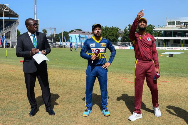 Shai Hope (R) of West Indies toss the coin as Kusal Mendis (C) of Sri Lanka and match referee Sir Richie Richardson (L) look on  during the 1st One Day International (ODI) cricket match between West Indies and Sri Lanka at Sabina Park in Kingston, Jamaica, on June 3, 2026. (Photo by Randy Brooks / AFP)