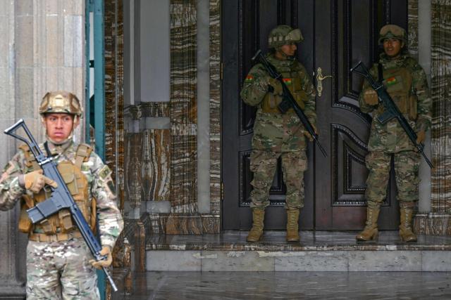 Military police stand guard outside the Government Palace at Murillo square in La Paz on June 3, 2026. Bolivia's defense and education ministers resigned on June 2, 2026 after weeks of protests demanding President Rodrigo Paz step down, authorities said. (Photo by AIZAR RALDES / AFP)