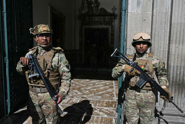 Military police stand guard outside the Government Palace at Murillo square in La Paz on June 3, 2026. Bolivia's defense and education ministers resigned on June 2, 2026 after weeks of protests demanding President Rodrigo Paz step down, authorities said. (Photo by AIZAR RALDES / AFP)