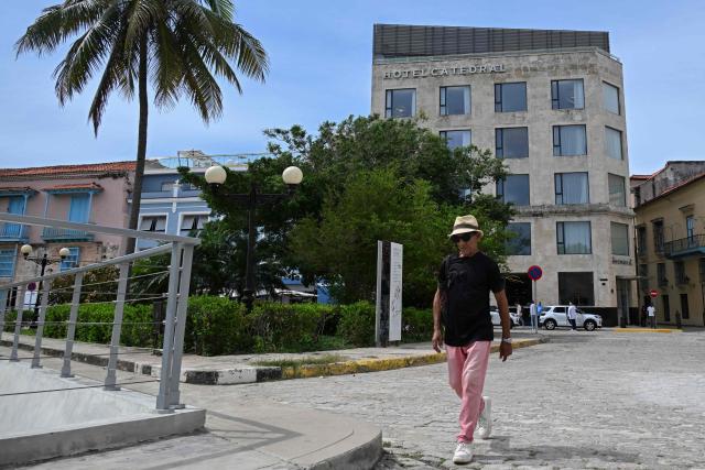 A man walks past the Innside Catedral Habana hotel on June 3, 2026. The Spanish hotel group Melia has stopped managing 15 hotels in Cuba that it operated in partnership with the Gaesa conglomerate, which is linked to the army and subject to United States sanctions (Photo by YAMIL LAGE / AFP)
