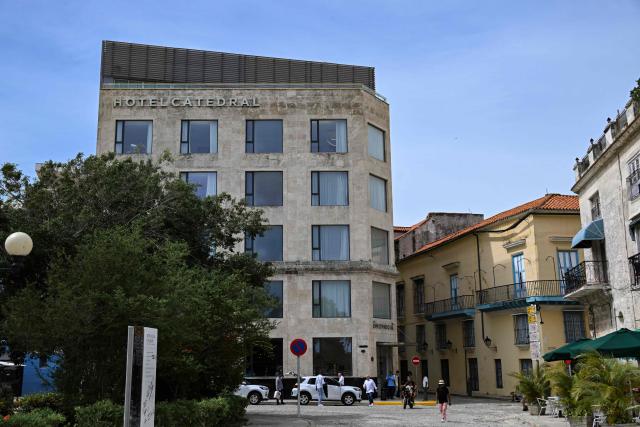 People walk past the Innside Catedral Habana hotel on June 3, 2026. The Spanish hotel group Melia has stopped managing 15 hotels in Cuba that it operated in partnership with the Gaesa conglomerate, which is linked to the army and subject to United States sanctions (Photo by YAMIL LAGE / AFP)