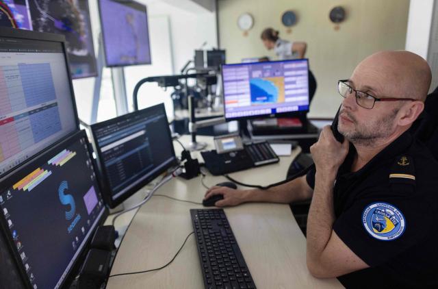 A shift supervisor monitors screens at the Cross-A (Regional operational monitoring and rescue center- A for Atlantic) in Etel, western France on June 3, 2026. In France, the CROSS units are responsible for search and rescue operations at sea. (Photo by Fred TANNEAU / AFP)