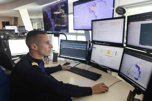 A shift supervisor monitors screens at the Cross-A (Regional operational monitoring and rescue center- A for Atlantic) in Etel, western France on June 3, 2026. In France, the CROSS units are responsible for search and rescue operations at sea. (Photo by Fred TANNEAU / AFP)