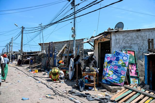 Residents gather their belongings to leave before the destruction of the precarious Zimbabwe neighbourhood during an eviction operation in the Port-Bouet neighbourhood in Abidjan on June 3, 2026. (Photo by Sia KAMBOU / AFP)